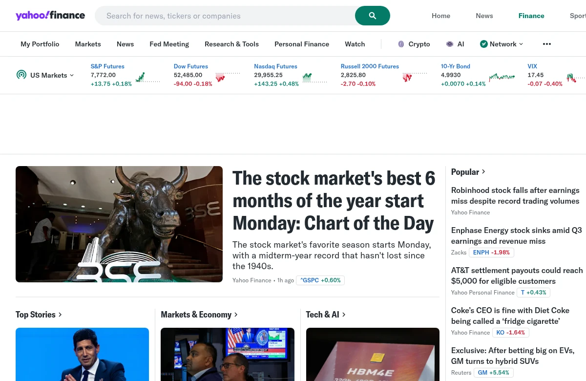 Yahoo Finance news homepage with market indices, headlines and a watchlist strip in light mode